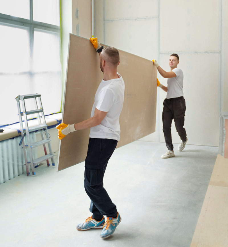Workers installing panelling during export fit-out